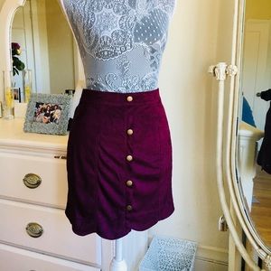 Plum suede mini skirt with button detailing.